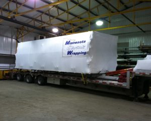 COMMERCIAL STRUCTURAL MEMBERS, WRAPPED AND SECURE FOR CROSS COUNTRY TRANSPORT